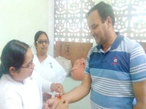 B.K. Preeti and B.K. Monika tying Rakhi to S.E. (Water Resources circle) C.L. Garg